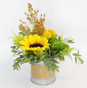 Sunflower and greenery in round vase