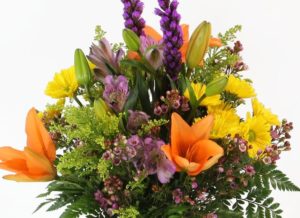 Send this bright bouquet to someone who needs a little sunshine in their day. A glass vase filled with Asiatic lilies, daisies and more.