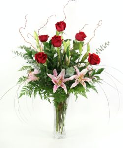 Roses and Lilies.The classic pairing of six premium long-stemmed roses designed with fragrant Oriental lilies in a flared glass vase. 30"t x 22"w