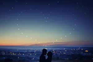 Night sky of love. Stars in heart shape and couple kissing
