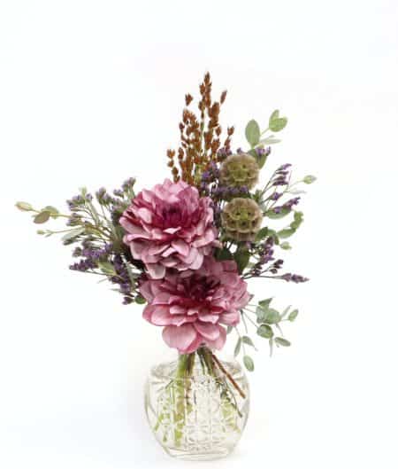 A charming flower bouquet with purple and lavender hues among natural fall greenery.